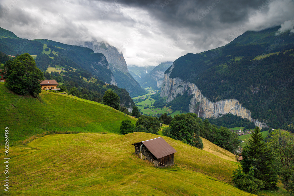 view from Wengen with farm shed through clouds into Lauterbrunnen valley