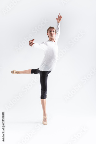 Portrait of Training Caucasian Young, Handsome Sporty Athletic Ballet Dancer with Lifted Hand Over White.