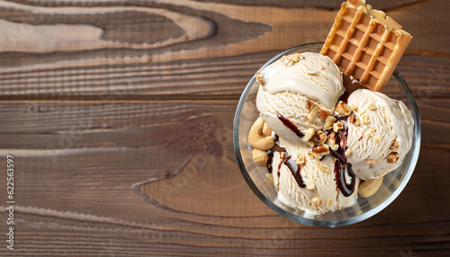 Принти на полотні Glass bowl of ice cream dessert with chocolate, nuts and waffle, from above clos