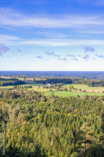 View at a forest landscape with fields in the countryside