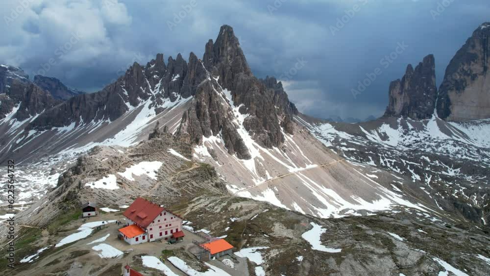 Scenic aerial shot of a pointy mountain with Locatelli Refuge. Tre Cime di Lavaredo, Dolomiti