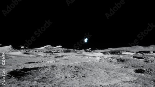4k slow wide forwards dolly shot of moon lunar landscape with earth just above horizon