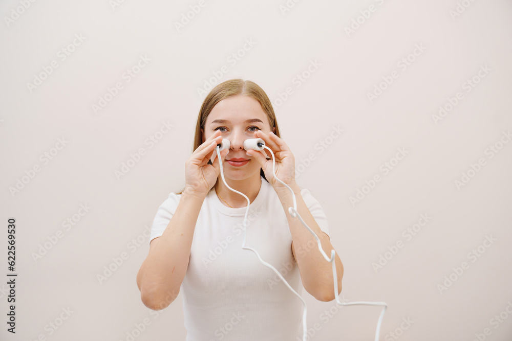 A patient on a magnetotherapy procedure on the nose A patient on a magnetotherapy procedure on the nose