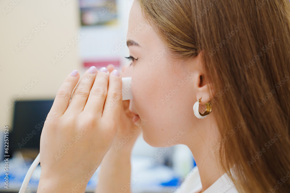 A patient on a magnetotherapy procedure on the nose A patient on a magnetotherapy procedure on the nose