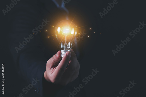 Light bulb in hand businessman, idea and creativity, personality, identity, distinctive, creative process and problem solving. 
