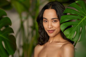 Portrait of beautiful tanned girl with natural makeup in the nature