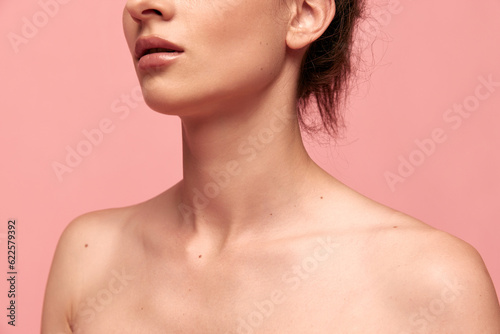 Cropped image of tender naked female body, shoulders and neck against pink studio background. Massage, spa. Concept of female beauty, body care, fitness, sport, health, figure, ad