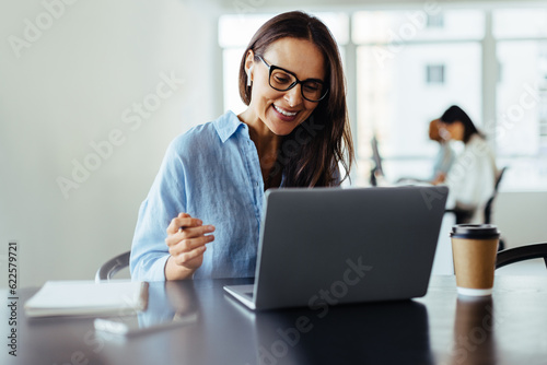 Woman having an online business meeting in an office photo