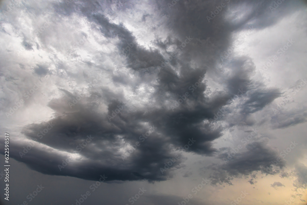 Obraz premium Dark thundercloud in a gray sky on a rainy morning in Inningen near Augsburg, Germany