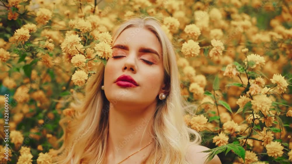 Fantasy sexy girl fairy in spring garden flowering tree. happy woman enjoy smell yellow flowers. white dress. Blonde curly hair lady inhales floral scent. Beauty face natural makeup pearl earrings. 4k Fantasy sexy girl fairy in spring garden flowering tree. happy woman enjoy smell yellow flowers. white dress. Blonde curly hair lady inhales floral scent. Beauty face natural makeup pearl earrings. 4k