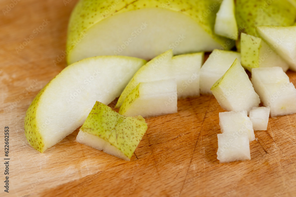 sliced green pear on a wooden board close-up sliced green pear on a wooden board close-up