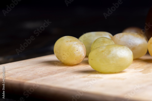 Homemade green unwashed grapes on a board