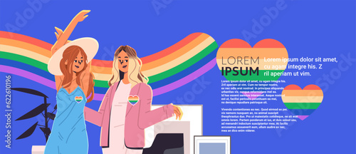 women with lgbt rainbow flags in heart shape standing together gay lesbian parade pride festival transgender love concept
