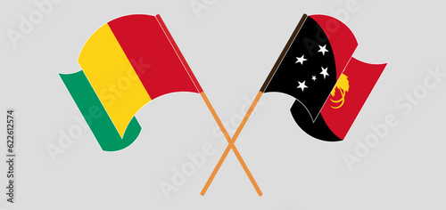 Crossed and waving flags of Guinea and Papua New Guinea