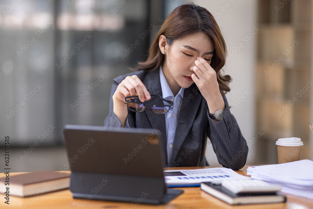 Portrait of tired young business Asian woman work with documents tax laptop computer in office. Sad, unhappy, Worried, Depression, or employee life stress concept
Portrait of tired young business Asian woman work with documents tax laptop computer in office. Sad, unhappy, Worried, Depression, or employee life stress concept