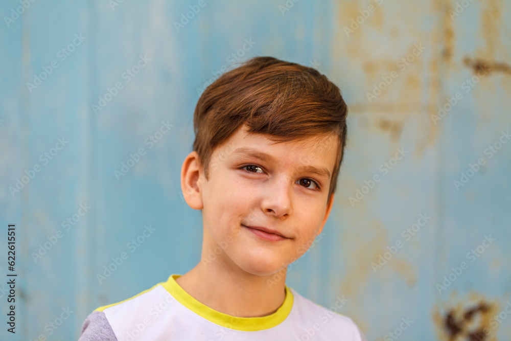 caucasian boy nine years old looking at the camera standing on the street. close-up caucasian boy nine years old looking at the camera standing on the street. close-up