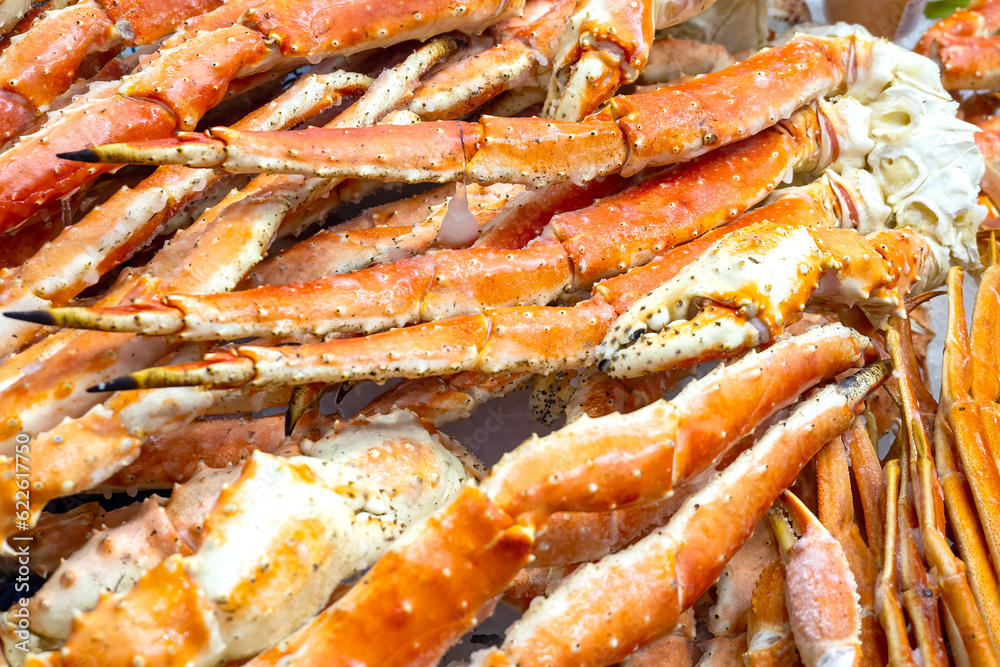Crab claws. Seafood background. Crab meat for cooking delicacies. Seafood store assortment. Red crab claws with delicious meat. Fish shop. Seafood for illustrating recipe book. Ingredient diet dinner Crab claws. Seafood background. Crab meat for cooking delicacies. Seafood store assortment. Red crab claws with delicious meat. Fish shop. Seafood for illustrating recipe book. Ingredient diet dinner