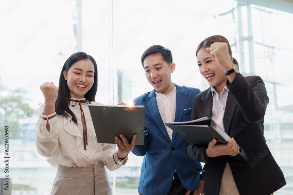 Diverse business team celebrate and collaboration and analyze financial data for long term investments Diverse business team celebrate and collaboration and analyze financial data for long term investments