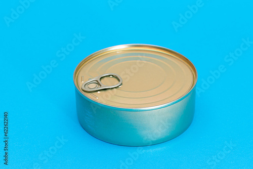 Unopened Tin Can with Blank Edge on Light Blue Background. Canned Food. Aluminum Can for Safe and Long Term Storage of Food. Steel Sealed Food Storage Container