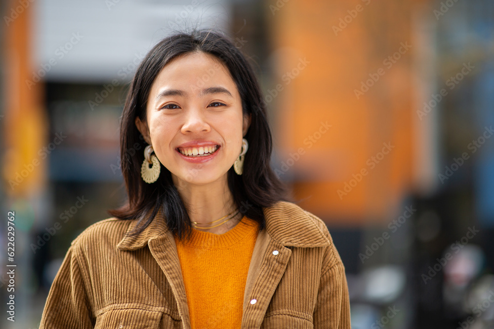 smiling young chinese woman looking at camera smiling young chinese woman looking at camera
