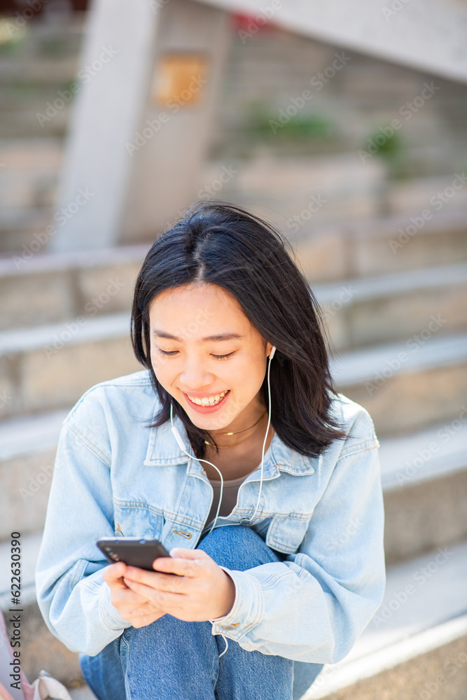 young woman looking at mobile phone