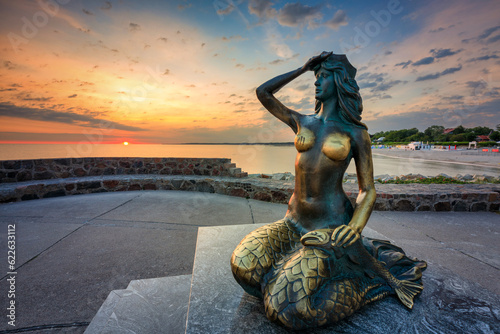 Fototapeta Naklejka Na Ścianę i Meble -  Mermaid statue by the Baltic Seain Ustka at sunrise. Poland