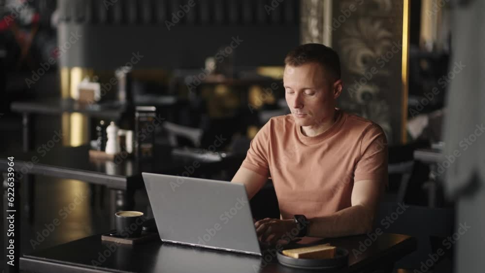 Freelancer Working With Laptop In Cafe, Smart Man Is Programmer Or Web Developer Freelancer Working With Laptop In Cafe, Smart Man Is Programmer Or Web Developer