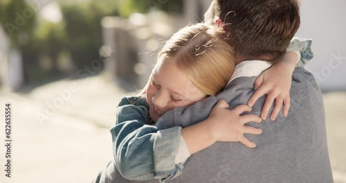 Father, girl and hug in street outdoor, bonding and happy together. Dad, embrace and cuddle with kid, child or daughter for love, care or affection, trust and welcome with family, security or comfort photo