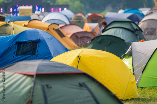 Fototapeta Naklejka Na Ścianę i Meble -  Multicolored tents on music festival campsite at park