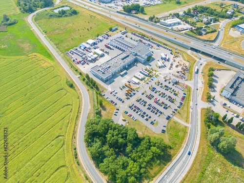 Aerial view of storage and freight terminal with trucks and containers. Industrial background. Logistic center.