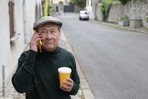 Serious looking ethnic man talking on the phone in urban setting 