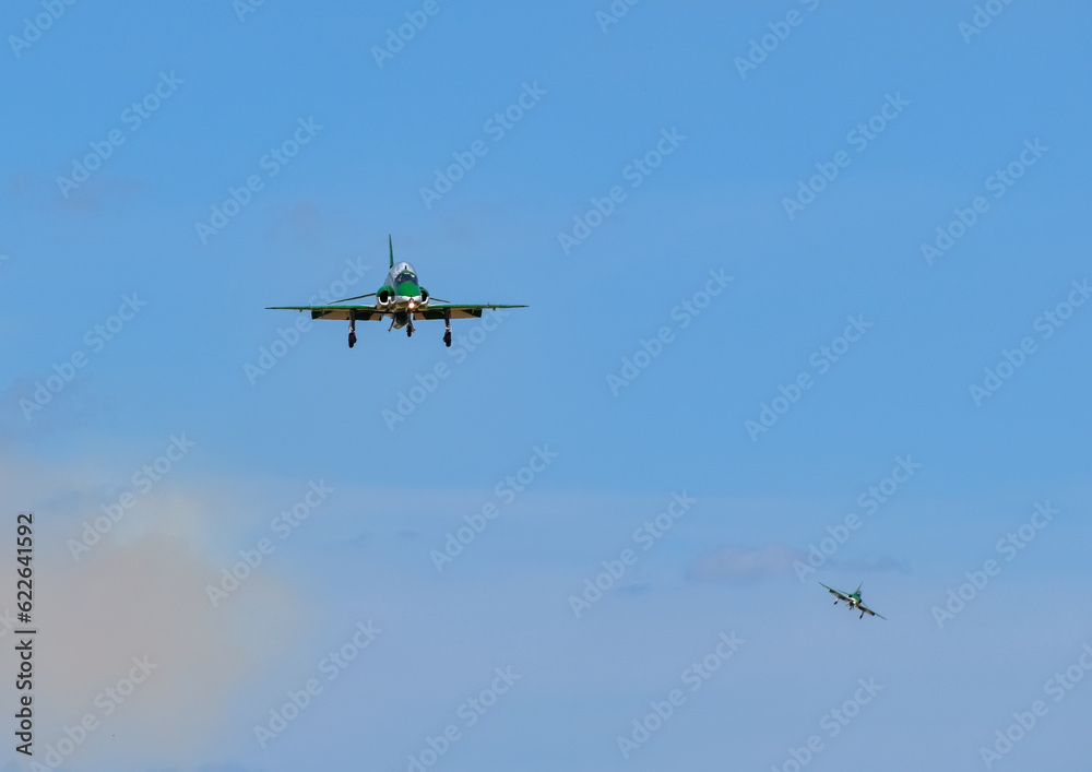 two green saudi Hawks falcons aerobatic team fighter jet coming in to land with blue skies air show display teams two green saudi Hawks falcons aerobatic team fighter jet coming in to land with blue skies air show display teams