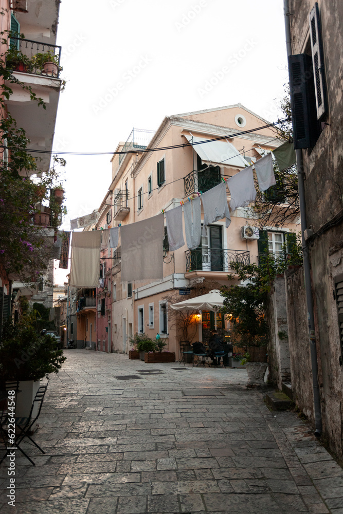 Rustic street with white clothes drying on line in Corfu old town in greece Rustic street with white clothes drying on line in Corfu old town in greece