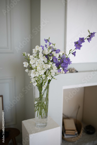 Bouquet of flowers in a vase. Stylish and bright room