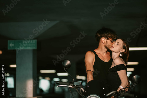 sexy couple in love on a motorcycle. Love of a man and a woman and a motorcycle