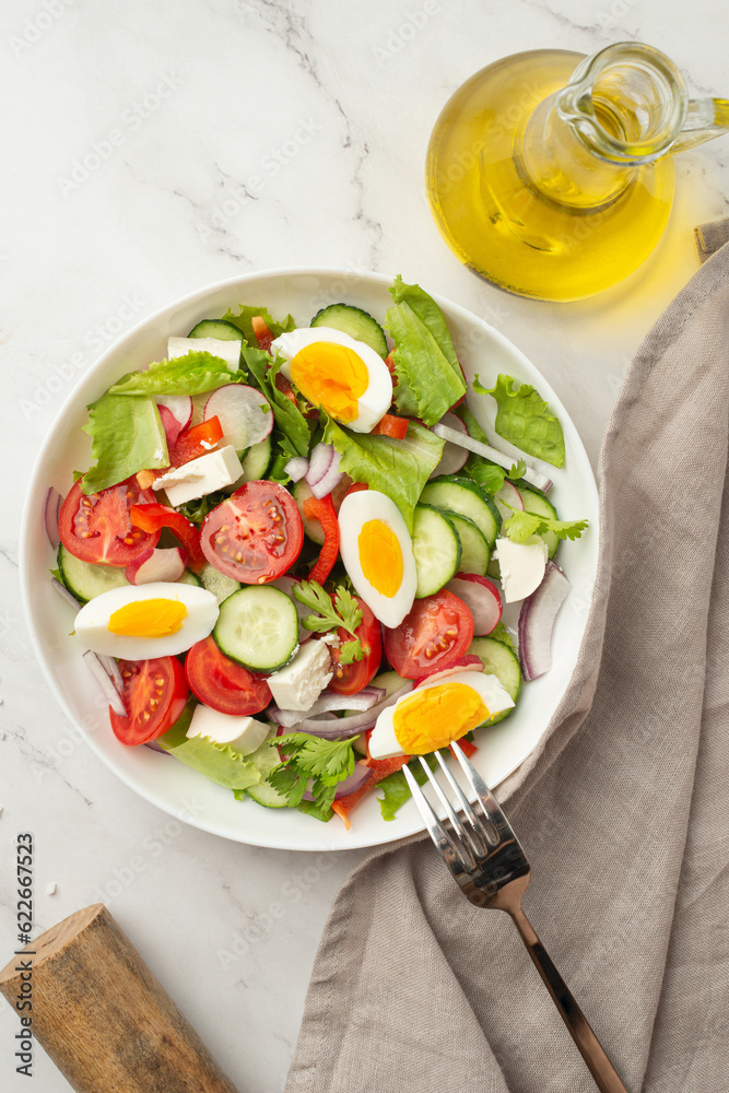 salad of fresh vegetables and greens with egg and feta cheese