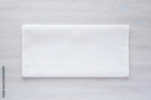 White waffle fabric kitchen towel mockup, folded blank cotton tea towel for design presentation, minimal composition. photo