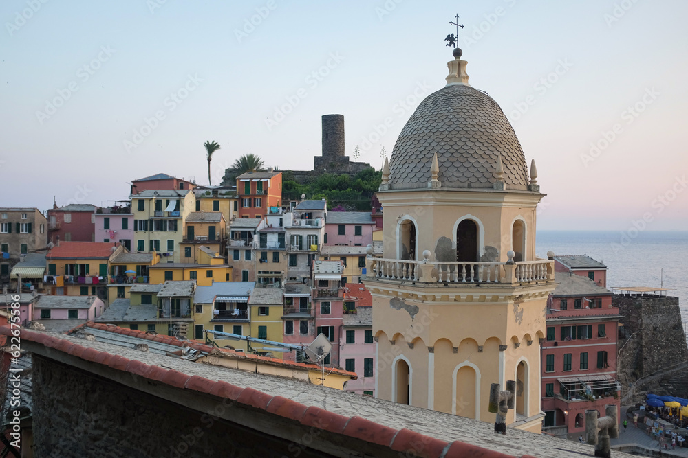 Cinque Terre, Italy - Church of Santa Margherita d'Antiochia tower in Vernazza, a seaside village on the rugged Italian Riviera coast. Summer travel vacation background. Postcard from Europe.
