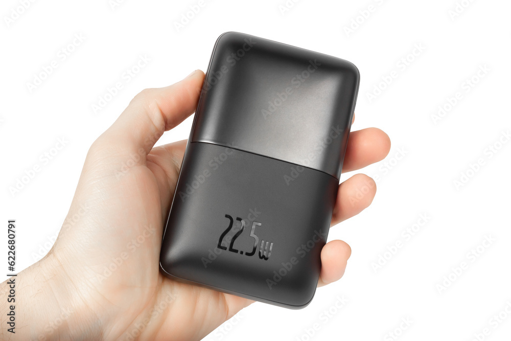 Power bank in hand isolated on white background. Power bank in hand isolated on white background.