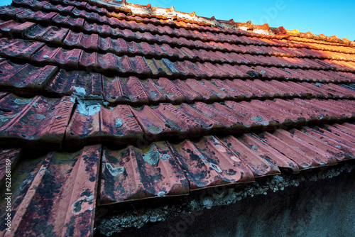 Fototapeta Naklejka Na Ścianę i Meble -  tiled roof of an old house close-up, architectural details