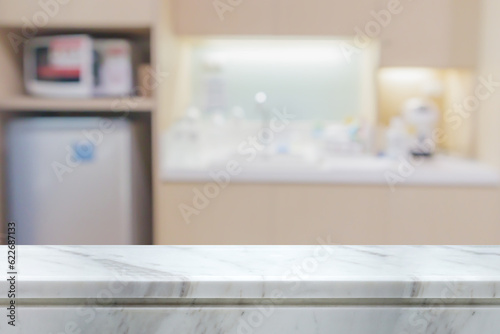 white marble stone counter top with blurred kitchen background © Piman Khrutmuang