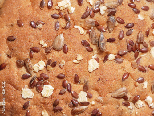 Close-up of wholemeal bread crust with flax, sunflower, sesame seeds and rolled oats.