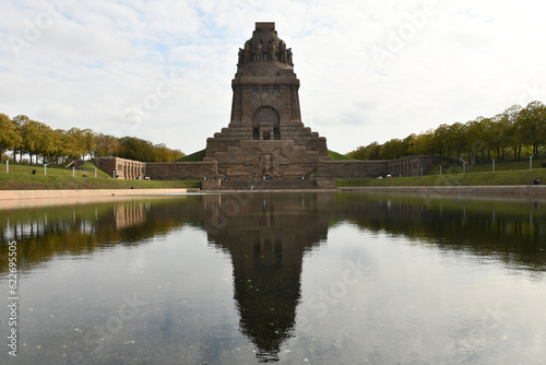 Pond reflecting the Monument to the Battle of the Nations in Leipzig  Germany against a cloudy sky