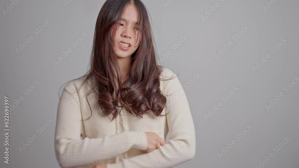 Portrait of Asian angry and sad hipster girl on a white screen background, The emotion of a hipster when tantrum and mad, expression of grumpy emotion. Teenager emotional control concept Portrait of Asian angry and sad hipster girl on a white screen background, The emotion of a hipster when tantrum and mad, expression of grumpy emotion. Teenager emotional control concept