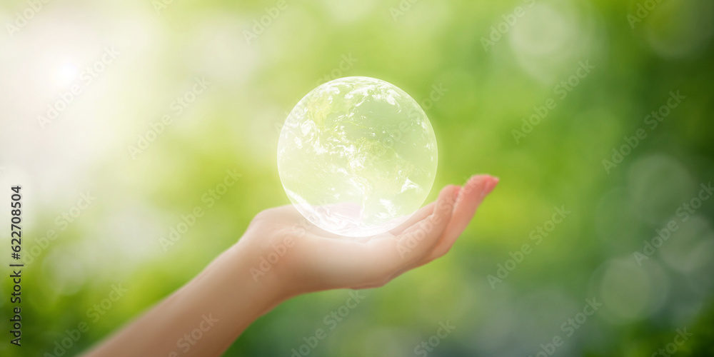 Hand holding earth on blurred natural background, environmental concept for ESG (Environment, Social and Governance), sustainable world environment