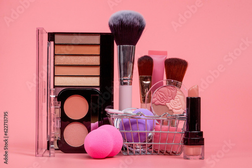 Professional makeup tools. Makeup products on pink background. A set of various products for makeup photo