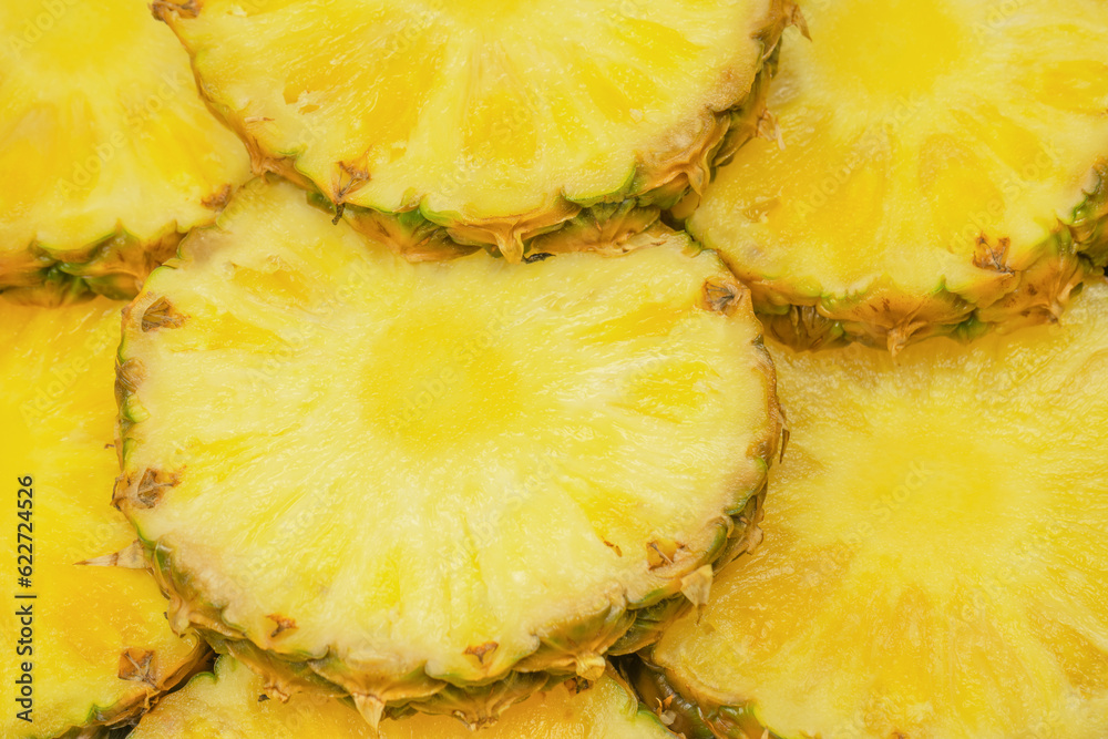 Pineapple juicy yellow slices as a background. Pineapple juicy yellow slices as a background.