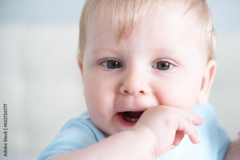 close up child with his fingers in his mouth, his teeth are teething. Baby teeth grow close up child with his fingers in his mouth, his teeth are teething. Baby teeth grow