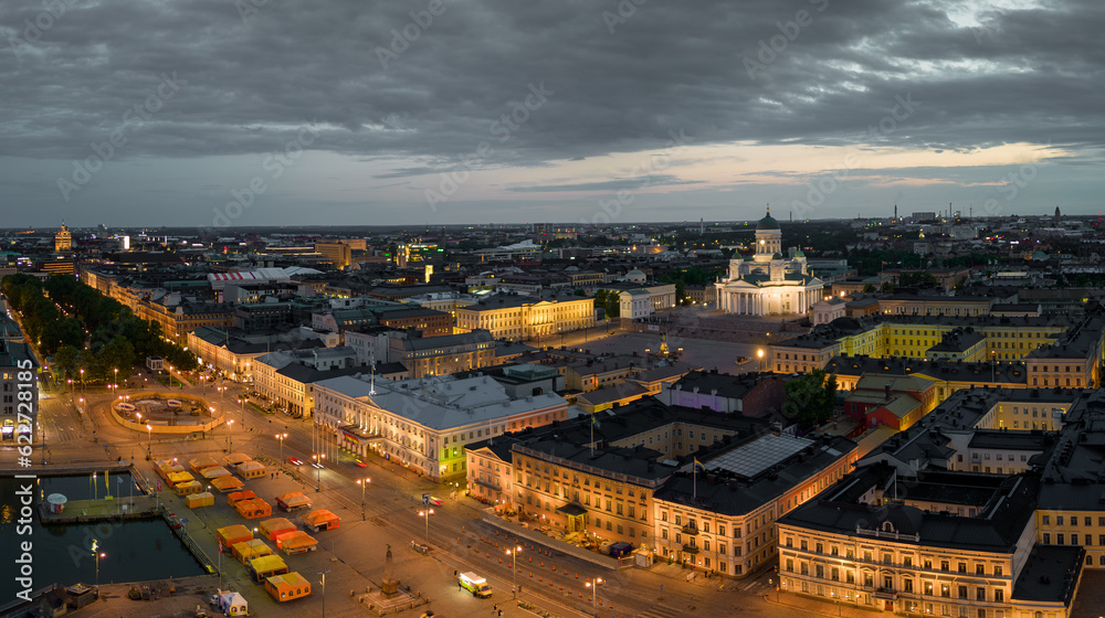 Fototapeta premium Helsinki Cathedral and Market Square by lit government buildings at dawn