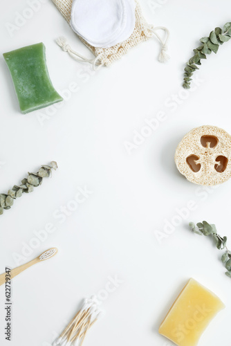 Natural organic eco cosmetics. Soap Eco, reusable cotton pads, loofah natural sponge washcloth, cotton swab, eucalyptus leaves on white background. Flat lay, top view, copy space